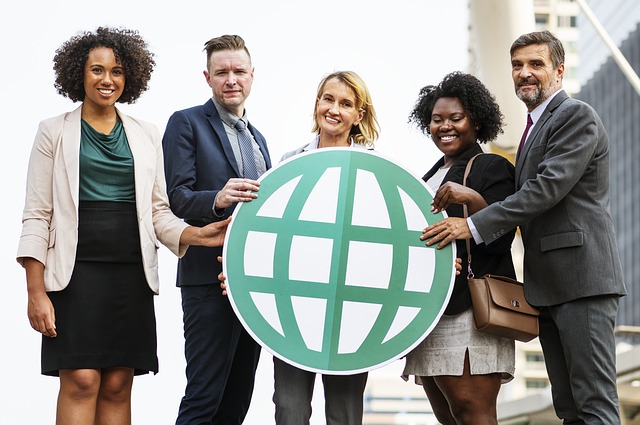 Business people embracing sustainability represented by a green globe
